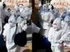 Covid Blast in China : lockdown extended, students with PPE kit